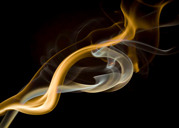 Abstract blue flowing light forms against a deep black background.