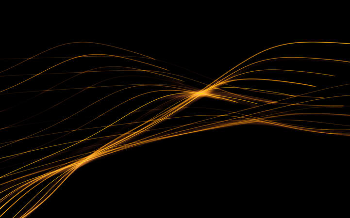 Abstract golden light trails flowing across a black background.